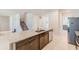Open concept kitchen with granite counters, stainless steel appliances, and adjacent staircase at 11086 Sundrift Dr, Tampa, FL 33647