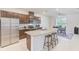 Modern kitchen with stainless steel appliances, dark cabinetry, and center island with granite countertops at 11086 Sundrift Dr, Tampa, FL 33647