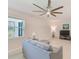 Comfortable living room with large windows, neutral decor, and ample natural light at 11086 Sundrift Dr, Tampa, FL 33647