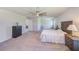 Large main bedroom boasts carpet, ceiling fan, natural light and ensuite bathroom at 11086 Sundrift Dr, Tampa, FL 33647