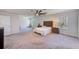 A spacious main bedroom offers carpet, ceiling fan and large windows providing natural light at 11086 Sundrift Dr, Tampa, FL 33647