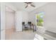 Well-lit office space with a ceiling fan, tile floor, and large window with neighborhood views at 11086 Sundrift Dr, Tampa, FL 33647