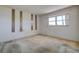 Bedroom featuring a bright window and unique wall accents at 11120 Carriage Hill Dr # 1, Port Richey, FL 34668