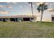 Rear exterior view of townhomes with lawn at 11120 Carriage Hill Dr # 1, Port Richey, FL 34668
