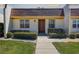 Charming single story home featuring a walkway leading to the front door and manicured bushes at 11120 Carriage Hill Dr # 1, Port Richey, FL 34668