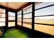Enclosed sunroom featuring multiple windows and outdoor views at 11120 Carriage Hill Dr # 1, Port Richey, FL 34668