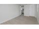 Neutral bedroom with gray wood-look floors that provides a view to a kitchen at 12087 105Th Ln, Largo, FL 33773