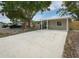 Charming home with a covered carport and a well-maintained new concrete driveway at 12087 105Th Ln, Largo, FL 33773