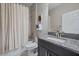 Bathroom featuring a shower-tub combo, granite countertop, and dark wood vanity at 13325 Sunset Shore Cir, Riverview, FL 33579
