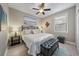 The relaxing bedroom with a ceiling fan, a large window, and luxury vinyl plank floors at 13325 Sunset Shore Cir, Riverview, FL 33579