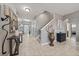 Spacious hallway with tile flooring, a staircase, and decorative accents, creating a warm and inviting atmosphere at 13325 Sunset Shore Cir, Riverview, FL 33579