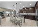 Modern kitchen featuring dark wood cabinetry, granite countertops, a kitchen island, and stainless steel appliances at 13325 Sunset Shore Cir, Riverview, FL 33579