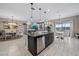 Open-concept kitchen with island, stainless steel appliances, and seamless flow to dining and living areas at 13325 Sunset Shore Cir, Riverview, FL 33579