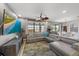Inviting living room with a large window, sectional seating, and access to the outdoor patio at 13325 Sunset Shore Cir, Riverview, FL 33579