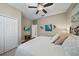 Bright main bedroom with light gray wood floors, ceiling fan, and stylish coastal decor at 13325 Sunset Shore Cir, Riverview, FL 33579