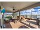 This screened patio has comfortable wicker seating and brick pavers around a covered hot tub at 13325 Sunset Shore Cir, Riverview, FL 33579