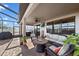 This screened patio has comfortable seating around a gas firepit, and an outdoor TV at 13325 Sunset Shore Cir, Riverview, FL 33579