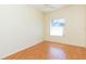 Bedroom with wood floors and window providing natural light at 1422 Distant Oaks Dr, Wesley Chapel, FL 33543