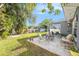 A beautiful patio with well maintained green lawn and flower beds in the spacious backyard at 1424 Orange St, Clearwater, FL 33756