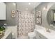 Cozy bathroom features a shower, vanity, modern fixtures, and a decorative shower curtain at 1424 Orange St, Clearwater, FL 33756