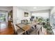 Bright dining room with hardwood floors, a wood table with bench seating, and large windows at 1424 Orange St, Clearwater, FL 33756