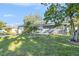 Charming single-story home with a well-manicured lawn and mature trees at 1424 Orange St, Clearwater, FL 33756