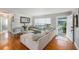 Bright living room featuring a large sectional sofa, wood floors, and stylish decor at 1424 Orange St, Clearwater, FL 33756