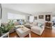 Cozy living room featuring a sectional sofa, wood floors, and large windows at 1424 Orange St, Clearwater, FL 33756