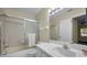 Bathroom featuring tile flooring, a walk-in shower, and a single vanity at 1438 Millstream Ln # 201, Dunedin, FL 34698