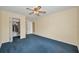 Bedroom featuring blue carpet and a walk-in closet at 1438 Millstream Ln # 201, Dunedin, FL 34698