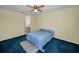 Well-lit bedroom with blue carpet and a private bathroom at 1438 Millstream Ln # 201, Dunedin, FL 34698
