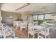 Community common area with tables, chairs, and a kitchenette at 1438 Millstream Ln # 201, Dunedin, FL 34698
