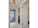 A view of the unit entryway with tile flooring, an outdoor porch, and an open doorway to the bedroom at 1438 Millstream Ln # 201, Dunedin, FL 34698