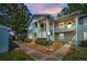 Two-story condo building with balconies and well-maintained landscaping at 1438 Millstream Ln # 201, Dunedin, FL 34698
