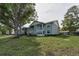 Building exterior showcases a well-maintained lawn, with spacious screened patio areas at 1438 Millstream Ln # 201, Dunedin, FL 34698