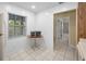 Bright kitchen area featuring a table and white tile floors and white walls at 1438 Millstream Ln # 201, Dunedin, FL 34698