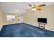 Spacious living room with blue carpet and modern ceiling fan and lighting at 1438 Millstream Ln # 201, Dunedin, FL 34698