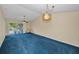 Cozy living area with bright lighting and plush carpeting at 1438 Millstream Ln # 201, Dunedin, FL 34698