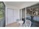 Screened porch with seating and lake view at 1438 Millstream Ln # 201, Dunedin, FL 34698
