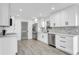 Modern kitchen featuring white cabinets, stainless steel appliances, and vinyl flooring at 1503 W Kirby St, Tampa, FL 33604