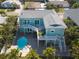 Aerial view of home featuring a pool, lush tropical landscaping, and a spacious outdoor living area at 16109 3Rd E St, Redington Beach, FL 33708