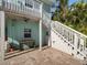 Backyard space featuring brick paved patio and stairs leading to a second story balcony at 16109 3Rd E St, Redington Beach, FL 33708