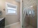 Close up of the bathroom with a shower, patterned glass and a sink with a granite countertop at 16109 3Rd E St, Redington Beach, FL 33708