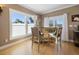 Bright breakfast nook with wood floors, stylish table and chairs and views of the outdoors at 16109 3Rd E St, Redington Beach, FL 33708