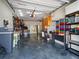 Spacious garage with ample storage, workbench, epoxy floor, and utility cabinets at 16109 3Rd E St, Redington Beach, FL 33708