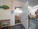 View of the garage, showing the entry to the home, and storage racks and a fish wall hanging at 16109 3Rd E St, Redington Beach, FL 33708