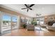 Cozy living room with hardwood floors, neutral decor, and a sliding glass door leading to an outdoor deck at 16109 3Rd E St, Redington Beach, FL 33708