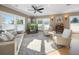 Bright living room with large windows, comfortable seating, and stylish decor at 16109 3Rd E St, Redington Beach, FL 33708