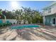 Charming backyard pool and patio surrounded by lush landscaping at 16109 3Rd E St, Redington Beach, FL 33708