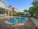 Backyard pool featuring brick paved patio area, outdoor seating, and tropical landscaping at 16109 3Rd E St, Redington Beach, FL 33708